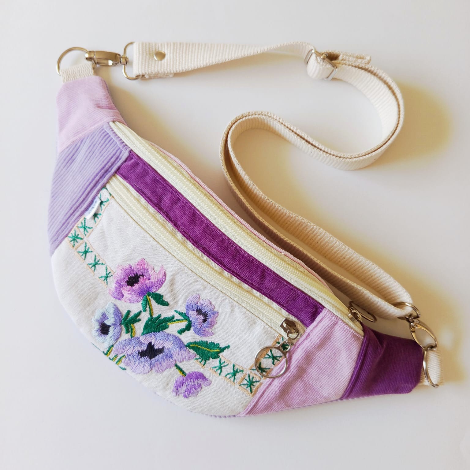 Handmade lilac corduroy moonbag with an embroidered floral panel