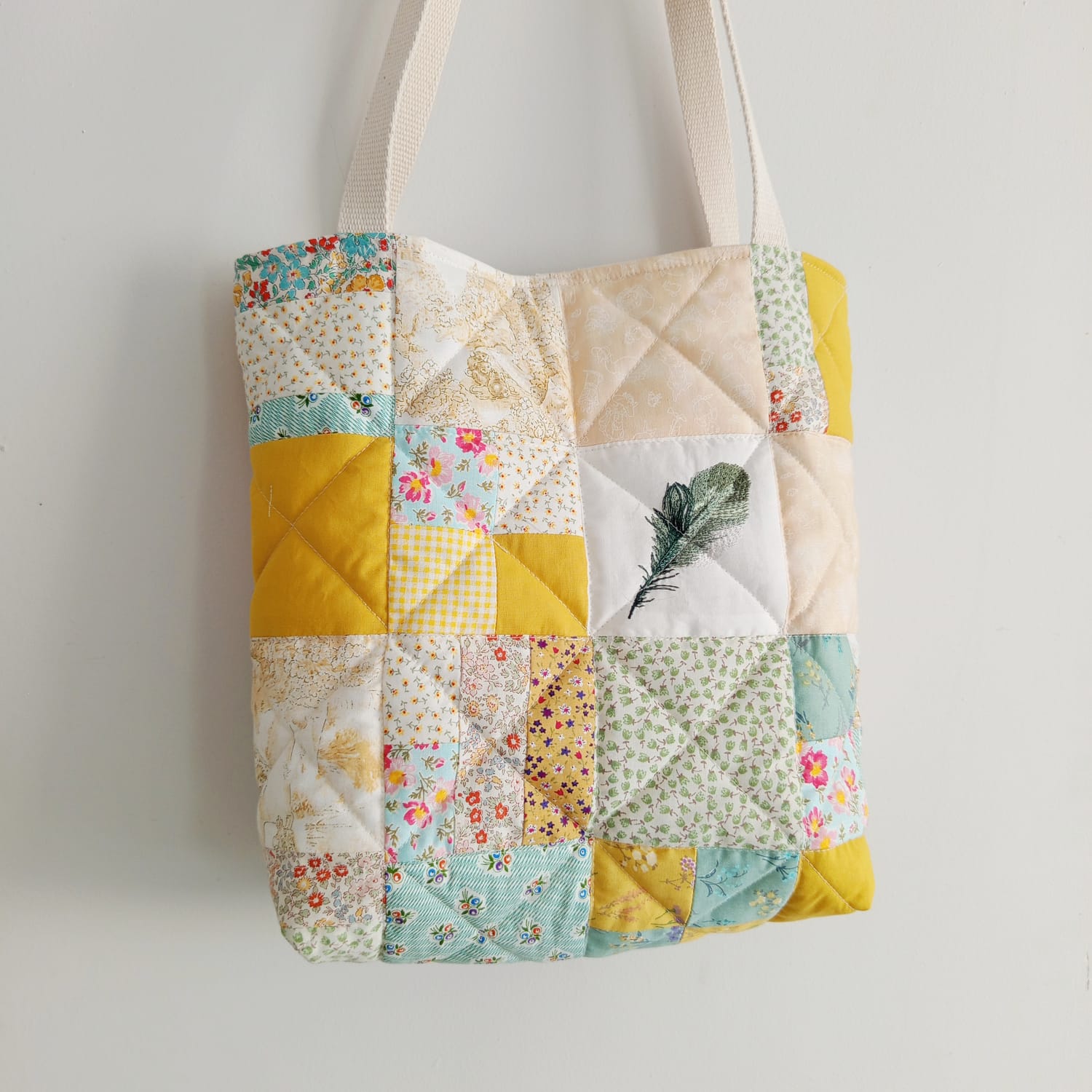 Patchwork tote bag made from vintage linen and floral fabric squares